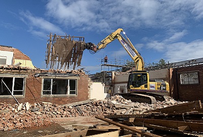 Digger demolishing a building